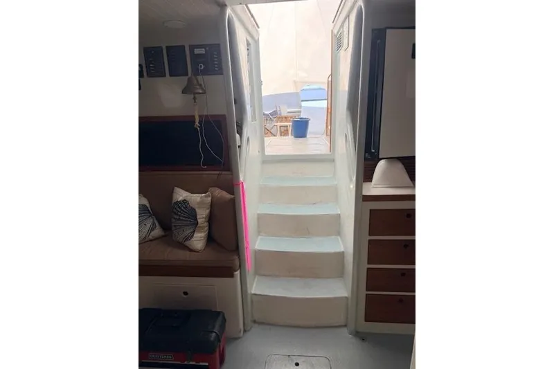 Slide: The Image of Interior view of 1978 Dyer 40 Custom Express Cruiser with stairs leading outside. - 63