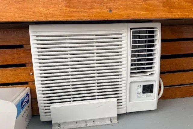 Slide: The Image of Air conditioning unit on 1978 Dyer 40 Custom Express Cruiser with wooden paneling. - 64