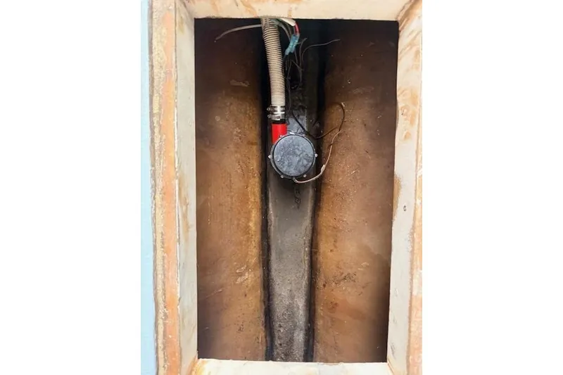 Slide: The Image of Bilge compartment of 1978 Dyer 40 Custom Express Cruiser with pump and wiring. - 65
