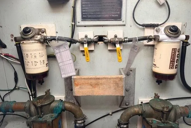 Slide: The Image of Engine room of 1978 Dyer 40 Custom Express Cruiser with fuel filters and valves. - 68