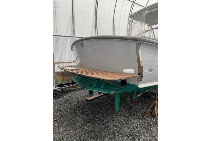 Slide: The Image of 1978 Dyer 40 Express Cruiser in storage, showcasing stern and propellers. - 7