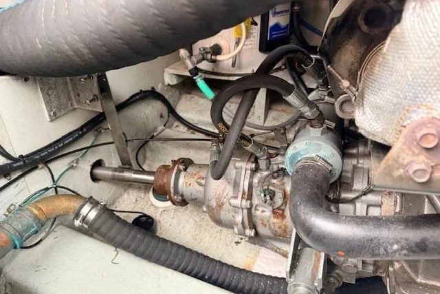 Slide: The Image of Engine compartment of a 1978 Dyer 40 Custom Express Cruiser, showing mechanical components and hoses. - 70