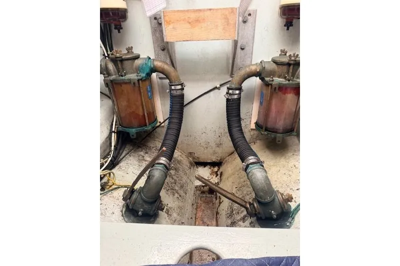 Slide: The Image of Engine room of 1978 Dyer 40 Custom Express Cruiser with visible fuel filters and hoses. - 72