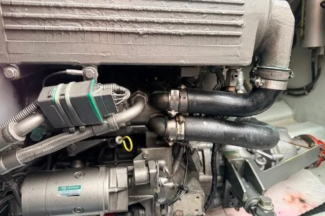 Slide: The Image of Engine components of a 1978 Dyer 40 Custom Express Cruiser, featuring hoses and connectors. - 73