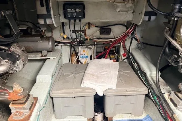 Slide: The Image of Engine room of 1978 Dyer 40 Custom Express Cruiser with visible wiring and equipment. - 79