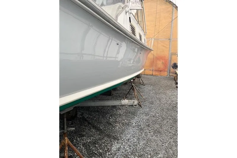 Slide: The Image of 1978 Dyer 40 Express Cruiser on stands in a boatyard. - 8