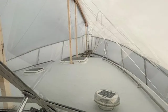 Slide: The Image of 1978 Dyer 40 Custom Express Cruiser under protective cover, showcasing deck and railing. - 80