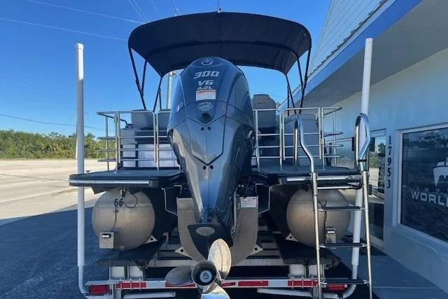 Slide: The Image of 2024 Starcraft SLS 3 Q DH pontoon boat with 300 V6 engine, rear view. - 2