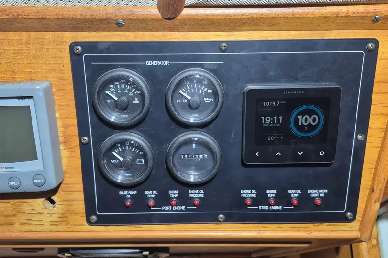 Slide: The Image of Control panel of a 1985 Grand Banks 42 Classic boat with gauges and digital display. - 108