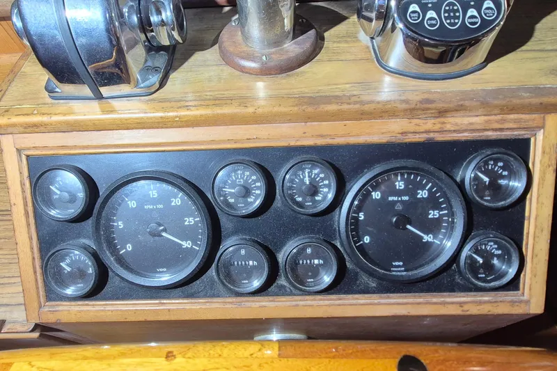 Slide: The Image of 1985 Grand Banks 42 Classic dashboard with gauges and controls, featuring RPM and pressure indicators. - 109