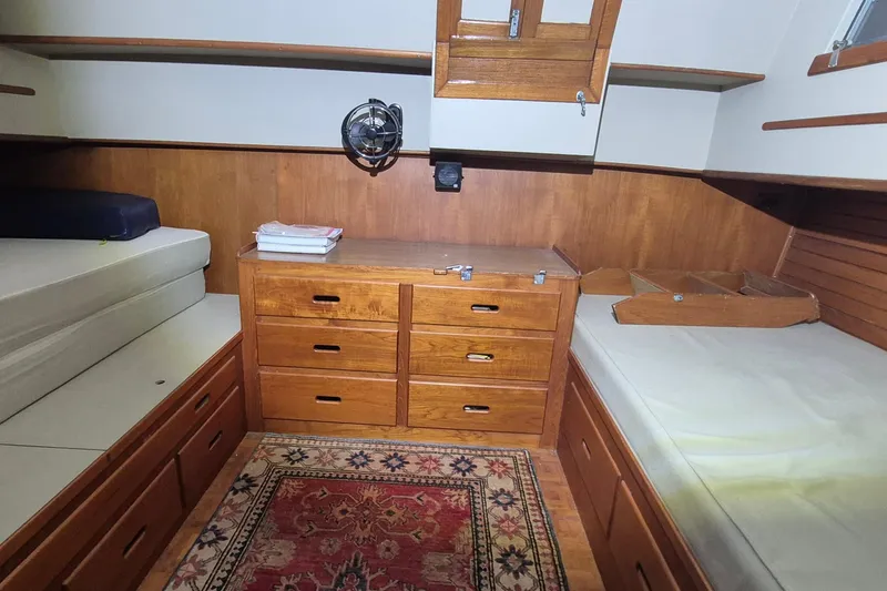 Slide: The Image of Interior of 1985 Grand Banks 42 Classic yacht with wooden cabinetry and twin beds. - 11