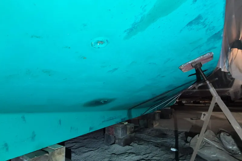 Slide: The Image of 1985 Grand Banks 42 Classic boat hull on supports in a shipyard. - 111