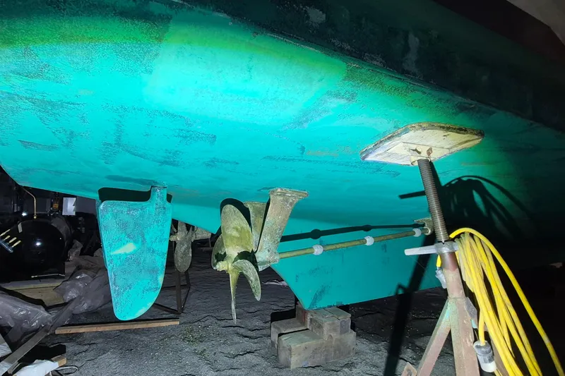 Slide: The Image of 1985 Grand Banks 42 Classic boat hull and propeller in dry dock maintenance. - 112