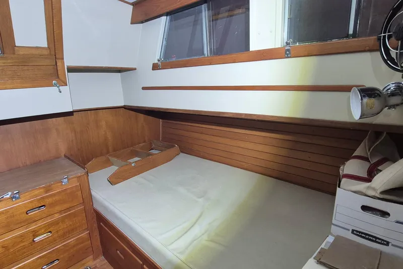 Slide: The Image of Cozy cabin interior of 1985 Grand Banks 42 Classic with wooden furnishings and storage. - 12