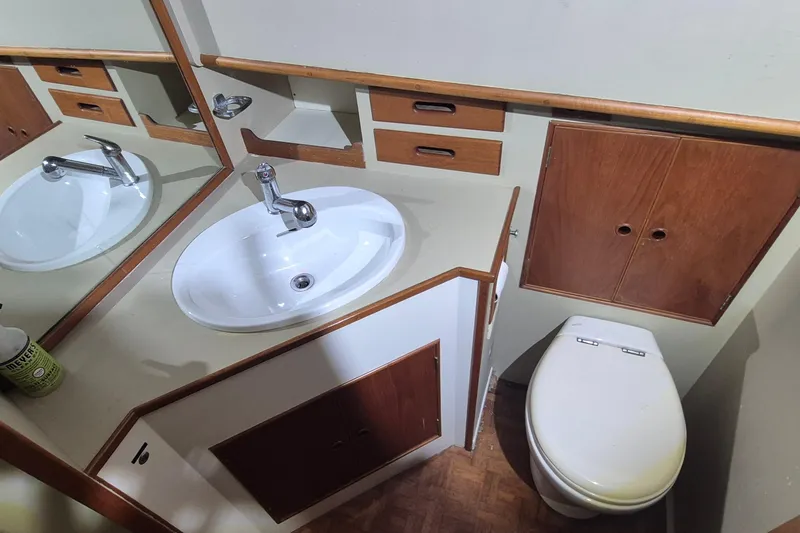 Slide: The Image of Bathroom interior of 1985 Grand Banks 42 Classic yacht with sink, mirror, and toilet. - 18