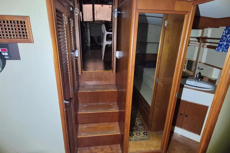 Slide: The Image of Interior of 1985 Grand Banks 42 Classic yacht, featuring wooden stairs and cabin area. - 19