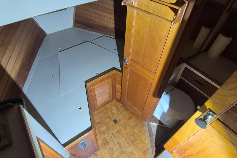 Slide: The Image of Interior of 1985 Grand Banks 42 Classic yacht, featuring wood paneling and compact bathroom. - 26