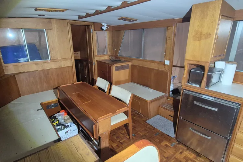 Slide: The Image of Interior of a 1985 Grand Banks 42 Classic yacht with wood furnishings and dining area. - 3