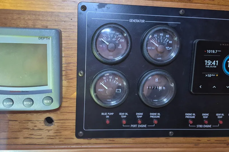 Slide: The Image of Control panel of a 1985 Grand Banks 42 Classic boat with gauges and displays. - 30