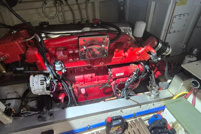 Slide: The Image of Engine room of a 1985 Grand Banks 42 Classic, featuring a red marine engine. - 34
