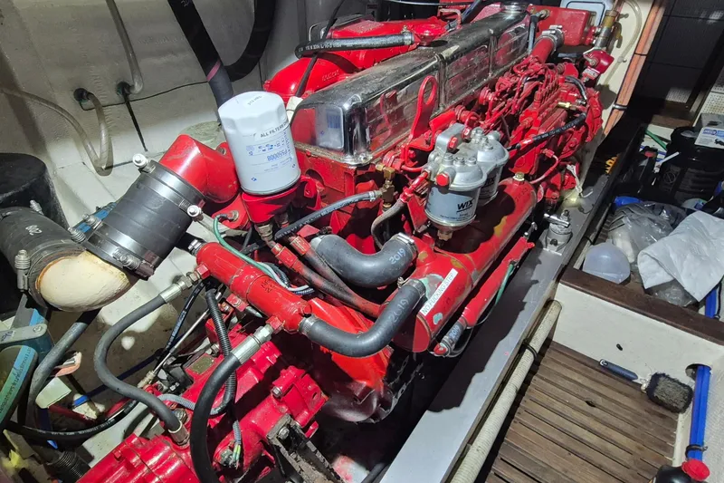 Slide: The Image of Engine room of a 1985 Grand Banks 42 Classic, featuring a red marine engine. - 35