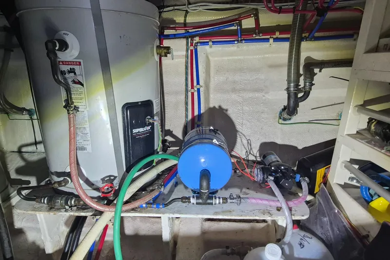 Slide: The Image of Engine room of 1985 Grand Banks 42 Classic with water heater and plumbing system. - 40