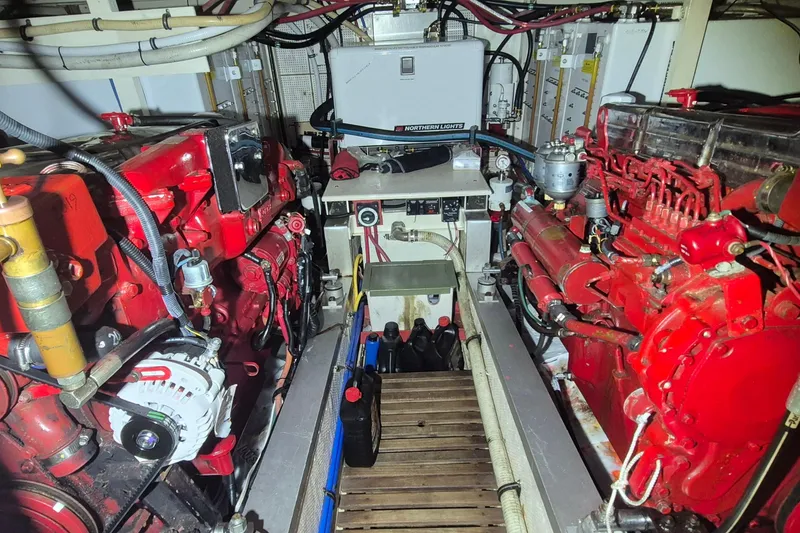 Slide: The Image of Engine room of a 1985 Grand Banks 42 Classic with red machinery and equipment. - 46
