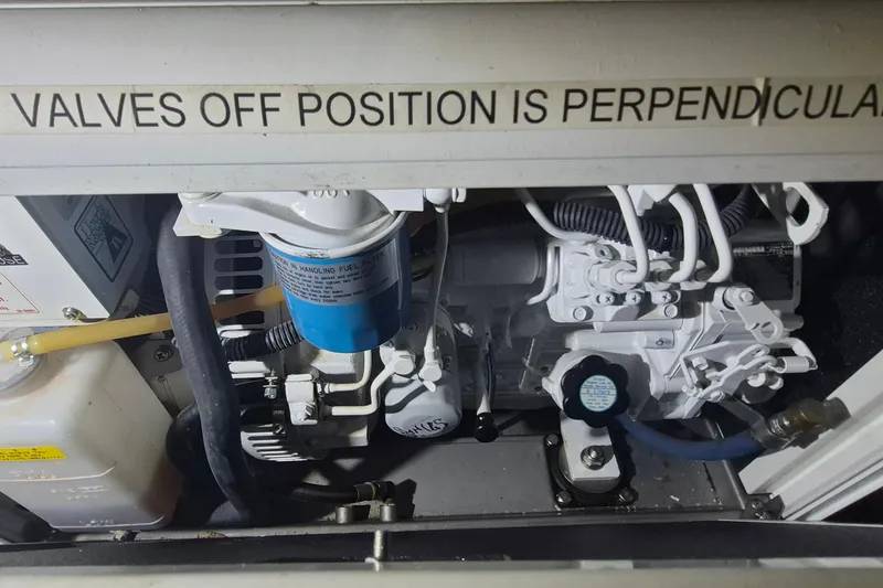 Slide: The Image of Engine compartment of 1985 Grand Banks 42 Classic with visible fuel filter and valves. - 49