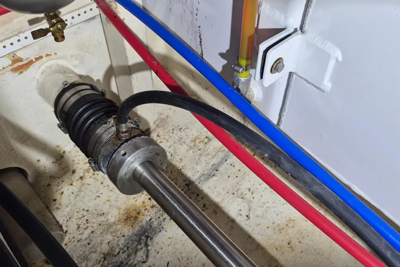 Slide: The Image of Engine room of 1985 Grand Banks 42 Classic with visible piping and mechanical components. - 55