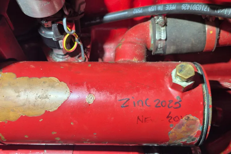 Slide: The Image of Engine compartment of 1985 Grand Banks 42 Classic with red components and zinc label. - 59