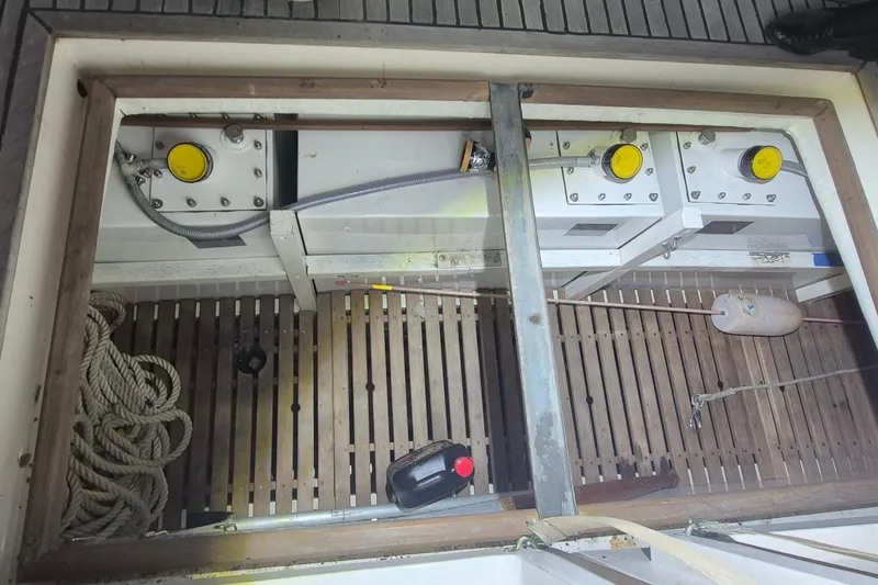 Slide: The Image of Engine compartment of 1985 Grand Banks 42 Classic with visible ropes and equipment. - 62