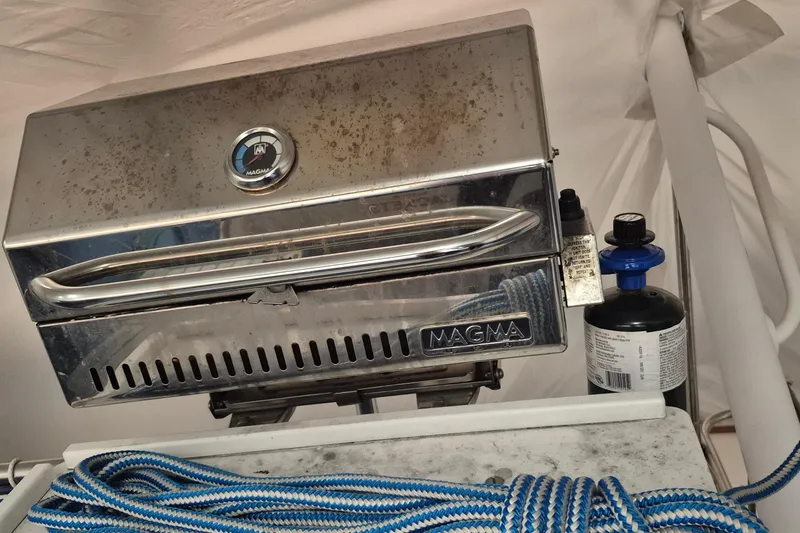 Slide: The Image of Stainless steel Magma grill on 1985 Grand Banks 42 Classic boat with propane tank. - 86