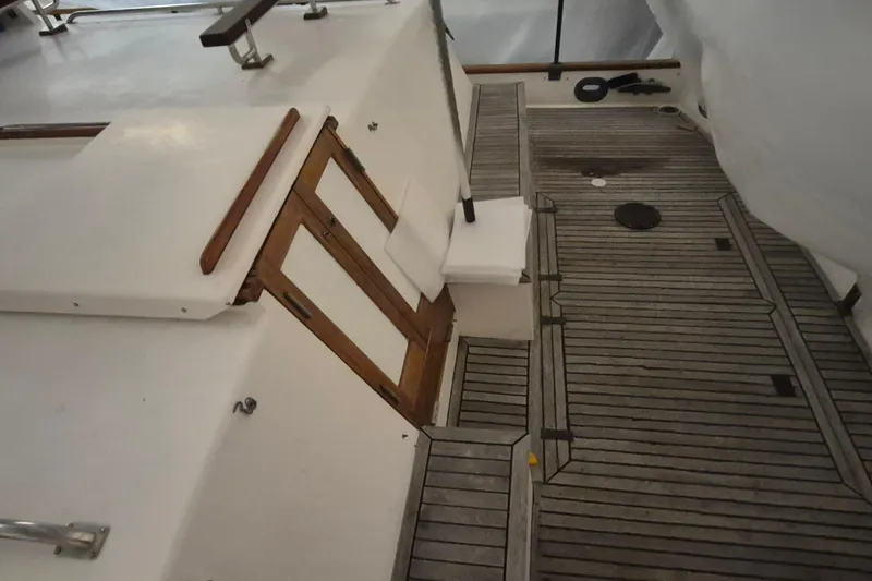Slide: The Image of 1985 Grand Banks 42 Classic yacht deck with wooden flooring and white cabin doors. - 90