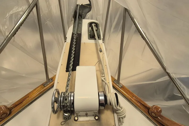 Slide: The Image of Bow of 1985 Grand Banks 42 Classic yacht with anchor chain and winch. - 93