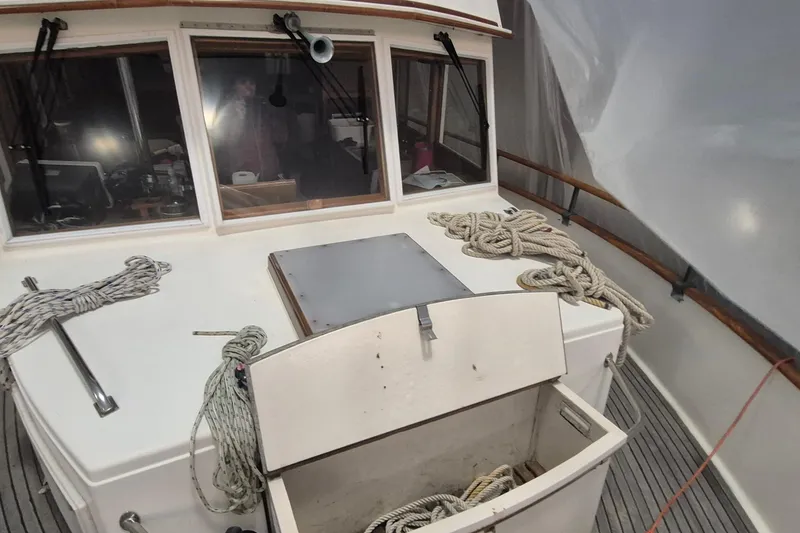Slide: The Image of 1985 Grand Banks 42 Classic boat deck with ropes and storage compartment. - 97
