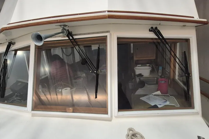 Slide: The Image of 1985 Grand Banks 42 Classic boat cabin with windows and wipers, showcasing interior details. - 99