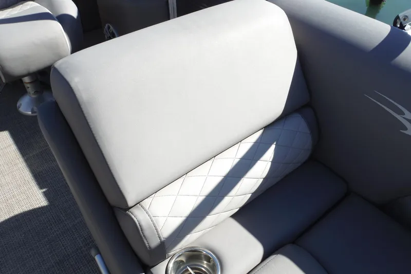 Slide: The Image of 2019 Bennington SX 22 SSRX boat interior with gray cushioned seating and cup holder. - 22