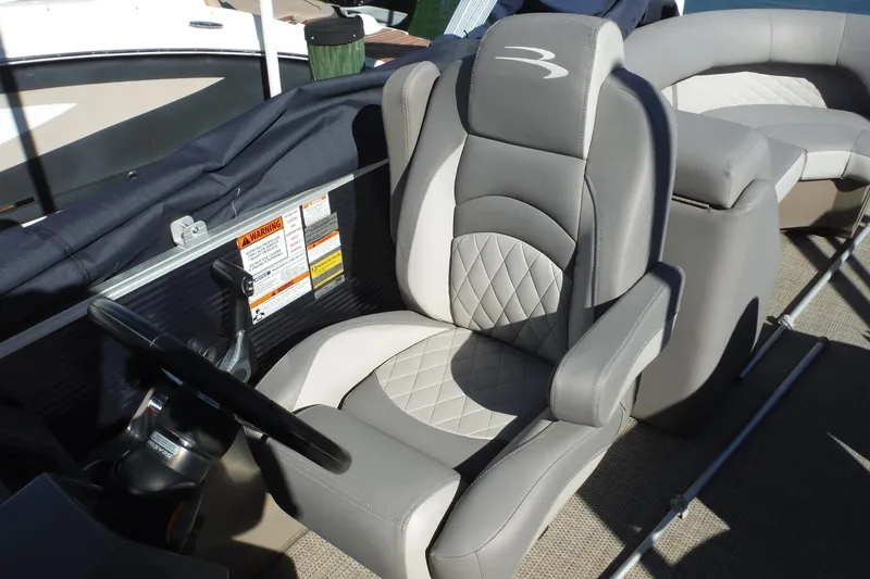 Slide: The Image of 2019 Bennington SX 22 SSRX boat interior with gray and white captain's chair. - 24