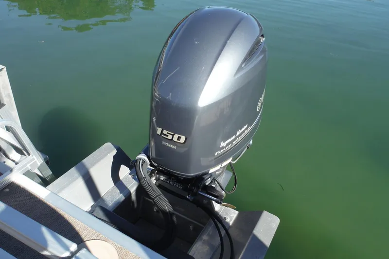 Slide: The Image of 2019 Bennington SX 22 SSRX with Yamaha 150 outboard motor on calm water. - 28
