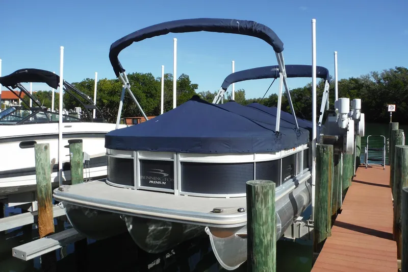 Slide: The Image of 2019 Bennington SX 22 SSRX pontoon boat docked with blue cover. - 29