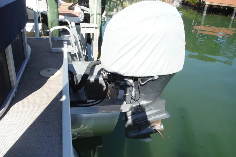 Slide: The Image of 2019 Bennington SX 22 SSRX boat engine with cover, docked on calm water. - 30