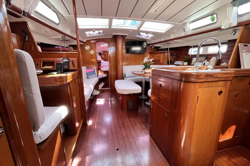 Slide: The Image of Interior of 2001 Beneteau 473 yacht, featuring elegant wood finish and modern amenities. - 10