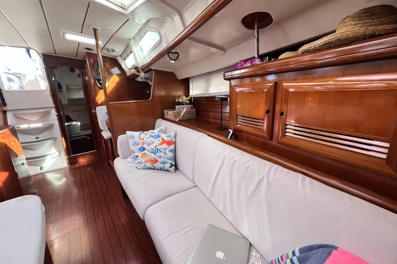 Slide: The Image of Interior of 2001 Beneteau 473 yacht with wooden finish and cozy seating area. - 11