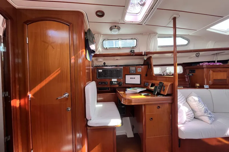 Slide: The Image of Interior of 2001 Beneteau 473 yacht with wooden finish and navigation station. - 14