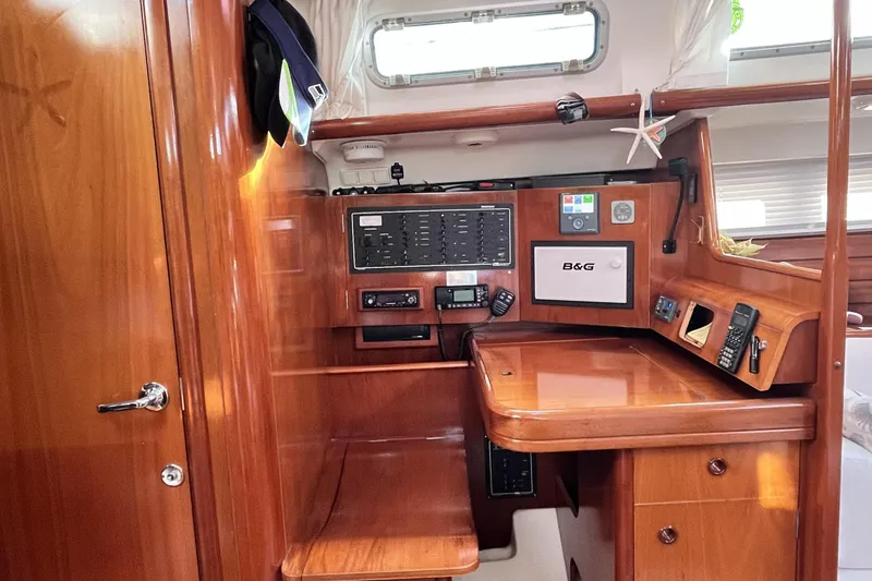 Slide: The Image of Interior of 2001 Beneteau 473 sailboat with navigation equipment and wooden finish. - 15