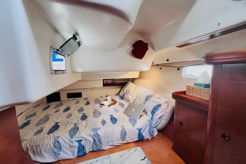 Slide: The Image of Cozy cabin interior of 2001 Beneteau 473 yacht with bed and wooden cabinetry. - 16