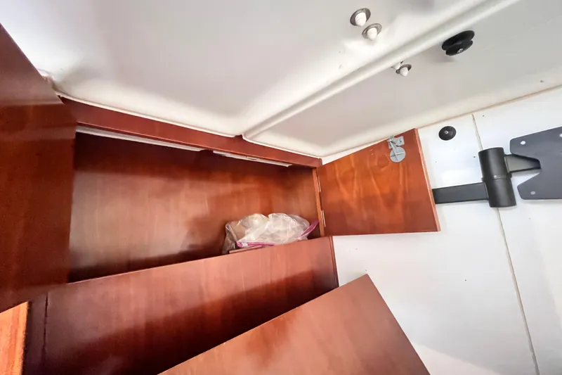 Slide: The Image of Interior storage compartment of a 2001 Beneteau 473 sailboat with wooden finish. - 19