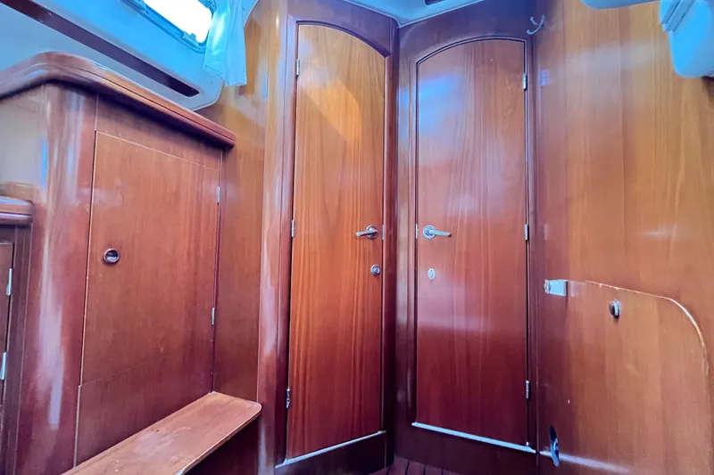 Slide: The Image of Interior of 2001 Beneteau 473 sailboat with wooden cabinetry and doors. - 20