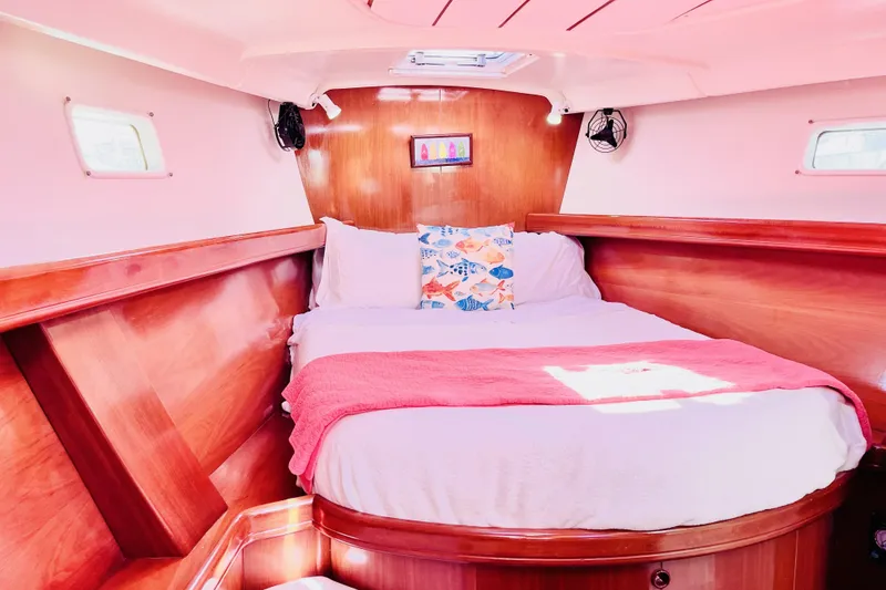 Slide: The Image of Cozy cabin interior of 2001 Beneteau 473 yacht with wooden finish and comfortable bedding. - 23