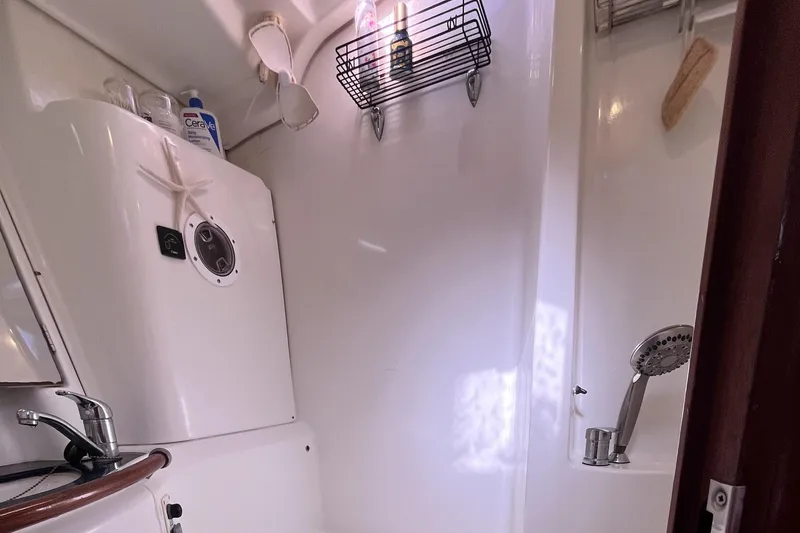 Slide: The Image of Beneteau 473 2001 yacht bathroom with shower, sink, and toiletries. - 28